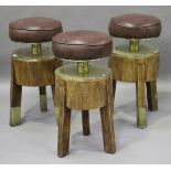 A set of three modern revolving bar stools with brown leather seats, height 72cm.Buyer’s Premium