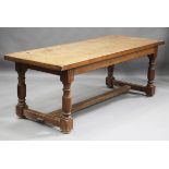 A 20th century Jacobean Revival pale oak refectory table, the thick plank top on turned and block