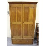 An Edwardian Arts and Crafts style oak wardrobe, possibly Cotswold School, the panelled doors and