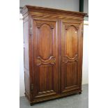 A 19th century French oak armoire, the two fielded panel doors enclosing two drawers, on stile