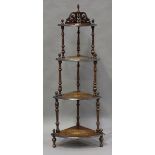 A late Victorian walnut corner whatnot with foliate inlaid decoration, height 147cm, width 57cm.