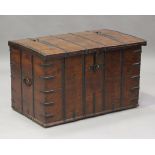 A 19th century Rajasthani teak and iron bound trunk, the hinged lid enclosing a candle box, the