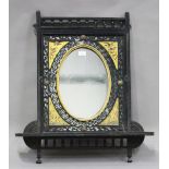 A late Victorian Aesthetic Movement ebonized wall mirror, the oval plate within gilded corners