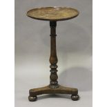 An early Victorian provincial oak wine table, the dished top with a turned baluster stem and triform