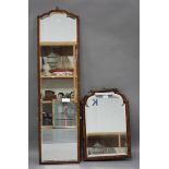 An early 20th century walnut framed wall mirror with a bevelled glass, 58cm x 40cm, together with