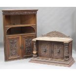 A late 19th century Baroque Revival carved oak cabinet, the two doors carved with lions' masks,