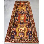 A Heriz runner, North-west Persia, late 20th century, the midnight blue field with four bold
