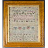 A George II needlework sampler by Charlotte Martin, dated 1758, finely worked in coloured silks with