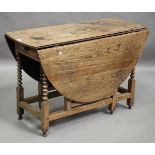 An 18th century oak oval gateleg dining table, fitted with a single drawer and raised on bobbin