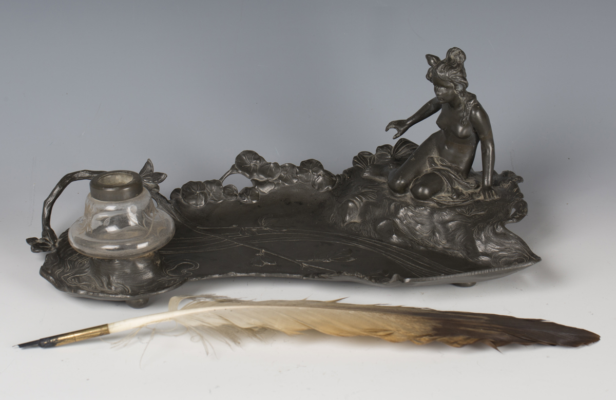 An Art Nouveau Argentor cast pewter inkstand, modelled in the form of a semi-clad maiden seated