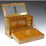 An Edwardian oak writing box, the hinged lid and fall front enclosing a letter rack, a writing