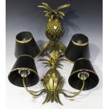 A pair of modern gilt painted wrought metal twin-light wall sconces of pineapple form, fitted with