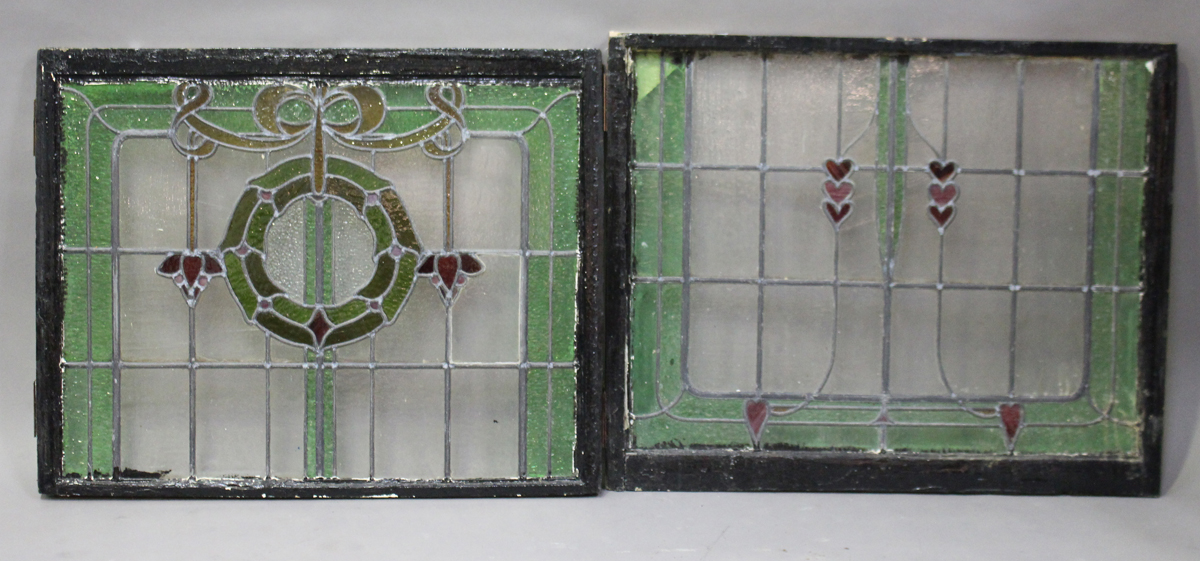 An early 20th century stained and leaded glass two-section window panel, worked with a design of a