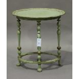 An early 20th century green and gilt painted oval occasional table, the piecrust top on turned legs,