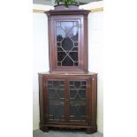 A late 19th century oak floor standing corner cabinet, fitted with astragal glazed doors enclosing