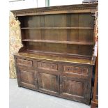 A mid-18th century oak dresser base, the three drawers with crossbanded borders, the later shelf