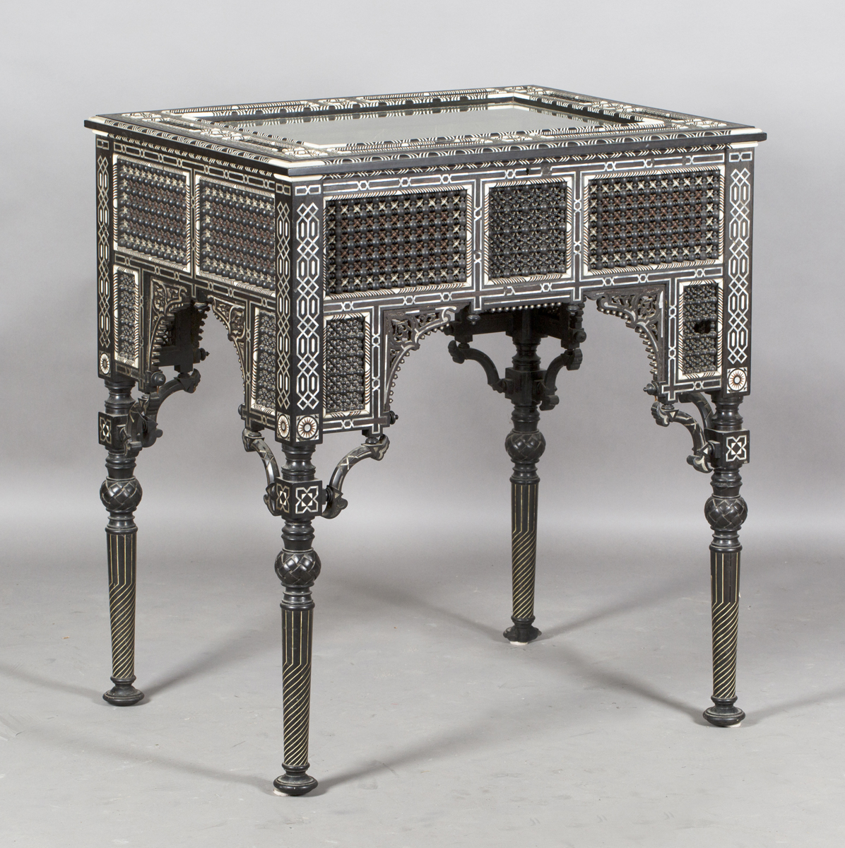 A late 19th century Middle Eastern ebonized bijouterie table, inset with overall panels of finely