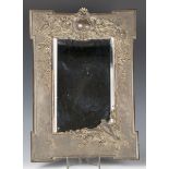 A late 19th century French brown patinated and coppered cast bronze dressing table mirror, the