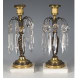 A pair of Regency brown and gilt patinated bronze table lustre candlesticks, hung with glass spear