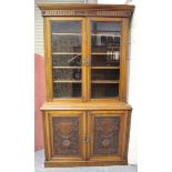 A late Victorian walnut bookcase cabinet, fitted with two glazed doors above a pair of doors
