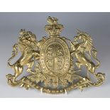 A 19th century pressed gilt brass Royal coat of arms armorial plaque, width 23cm.Buyer’s Premium