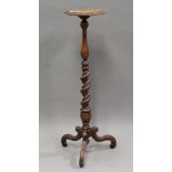 An early 20th century William and Mary style walnut torchère, the barley twist stem raised on tripod