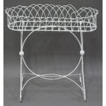 An early 20th century wirework plant pot stand, raised on a pair of scroll supports, height 72cm,