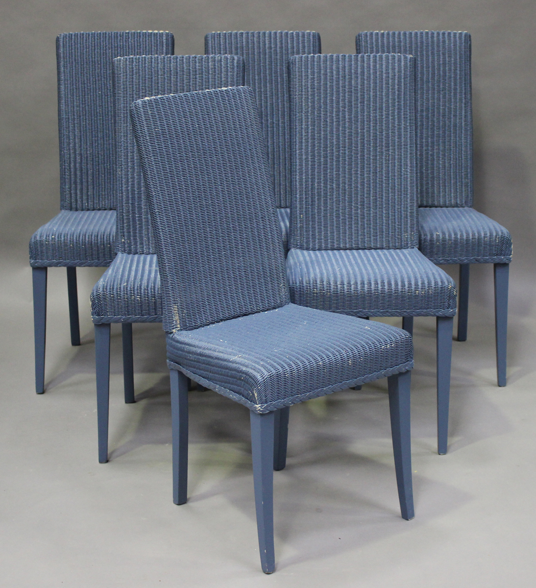 A set of six modern Lloyd Loom blue painted dining chairs, raised on square tapering legs, height