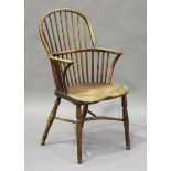 A mid-19th century yew and elm hoop and stick back Windsor armchair with a crinoline stretcher,