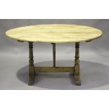 An early 20th century French pine tilt-top vendange or wine tasting table, the oval top on a trestle