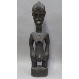An African carved and stained wooden standing figure, height 98cm.Buyer’s Premium 29.4% (including