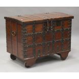 A large 19th century Rajasthani teak and iron bound wheeled trunk, the hinged lid with twin