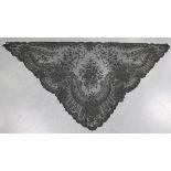 A late 19th/early 20th century Chantilly black lace triangular shawl, finely worked with floral