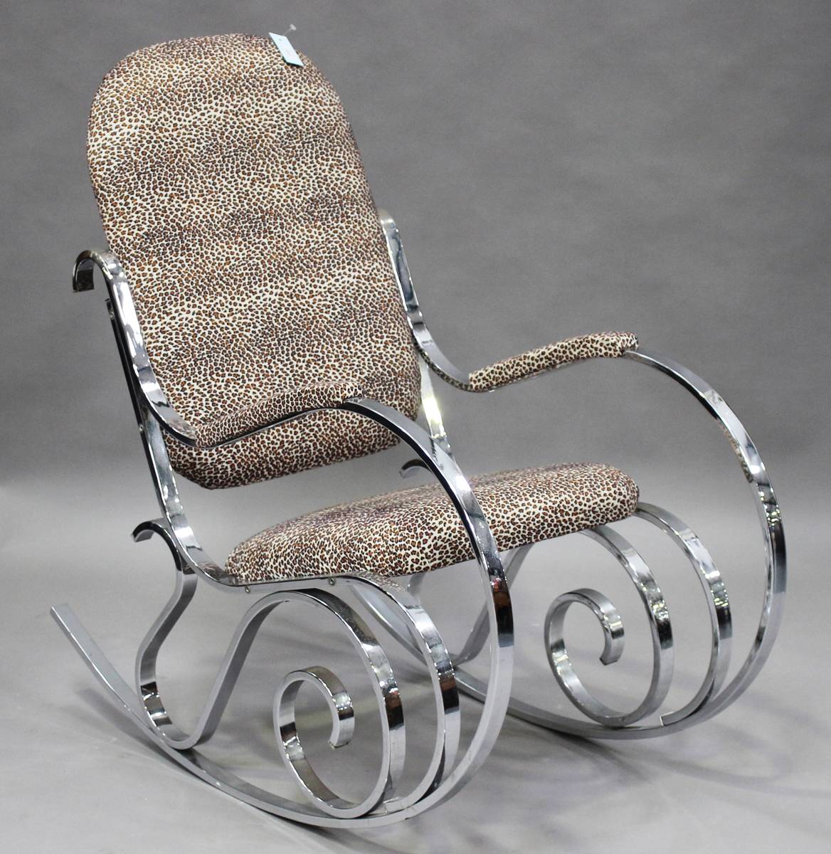 A Maison Jansen Thonet style chromium plated scrollwork rocking chair, the seat, back and armrest