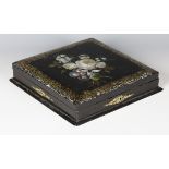 A Victorian papier-mâché games box, the square hinged lid inlaid in mother-of-pearl and painted with
