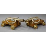 A pair of modern ornamental bronze model ships' cannon, barrel length 40cm, mounted on solid beech