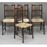 A set of four early 20th century stained oak spindle back dining chairs with rush seats, height