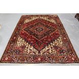 A Heriz carpet, North-west Persia, mid-20th century, the red field with a bold hooked medallion,