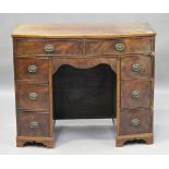 A George III and later figured mahogany bowfront kneehole dressing table, fitted with eight drawers,