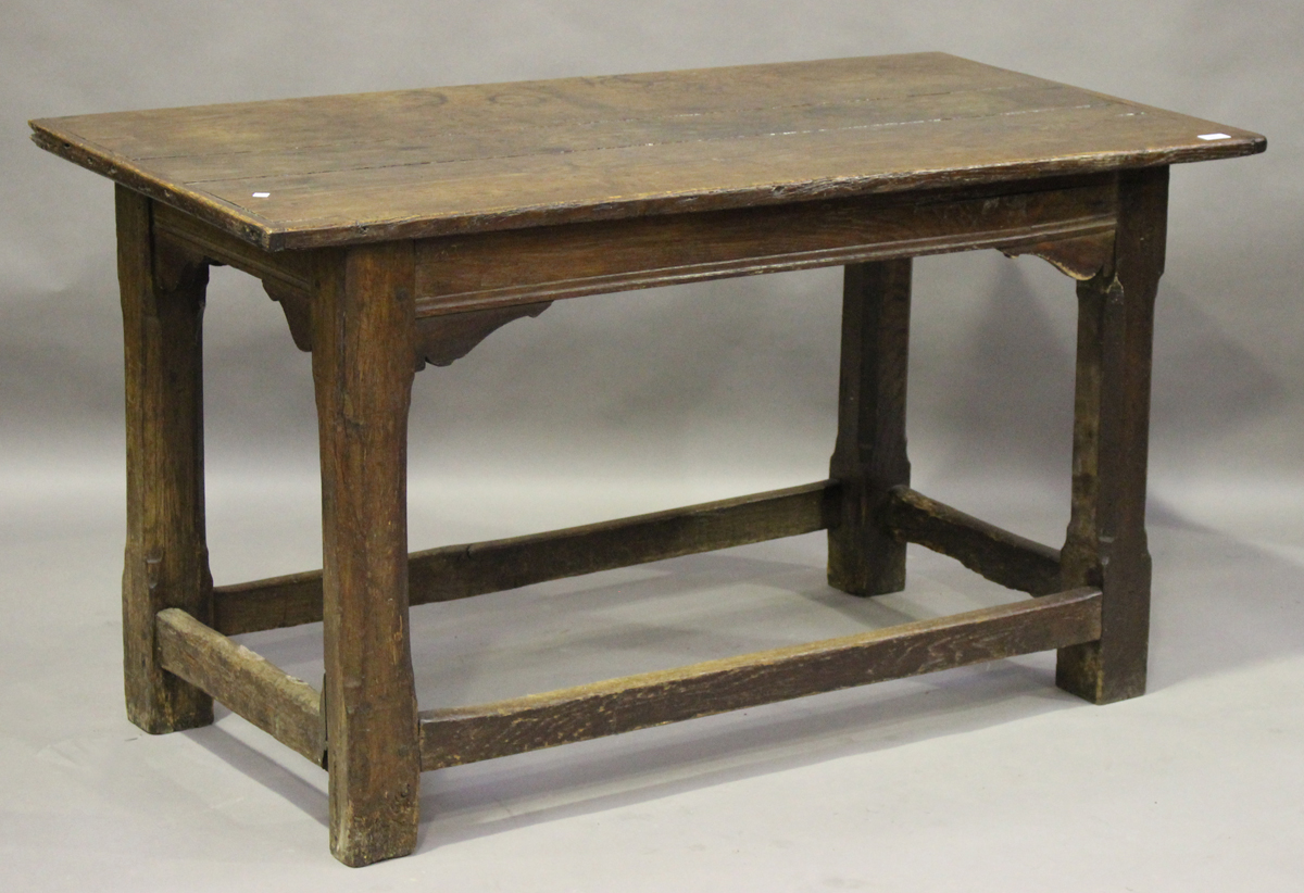 A 17th century and later oak refectory table, the cleated three-plank top on chamfered block legs