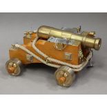 A modern brass ornamental model of an Armstrong Whitworth naval cannon, barrel length 33cm,