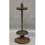 A late 19th century mahogany revolving snooker cue stand, raised on a flared circular base, height