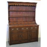 A late 20th century reproduction oak dresser, the shelf back above drawers and cupboards, on stile