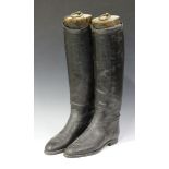 A pair of 20th century black leather gentleman's riding boots, fitted with wooden lasts.Buyer’s