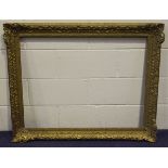 A large gilt composition Watts style picture frame, rebate 72cm x 92cm, together with two other gilt