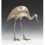 A Japanese silvered bronze model of a red-capped crane, Meiji period, standing with lowered head,