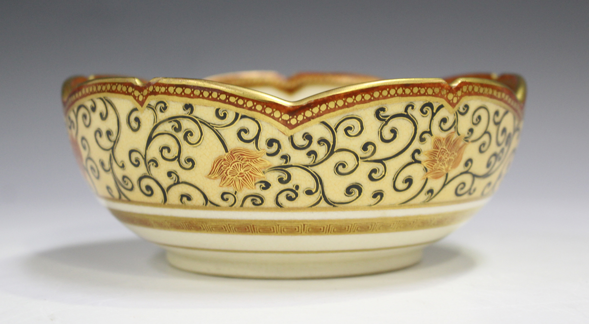 A Japanese Satsuma earthenware circular bowl with scalloped rim, Meiji period, painted to the