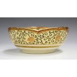 A Japanese Satsuma earthenware circular bowl with scalloped rim, Meiji period, painted to the