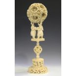 A Chinese Canton export ivory concentric puzzle ball and stand, late Qing dynasty, the outer case