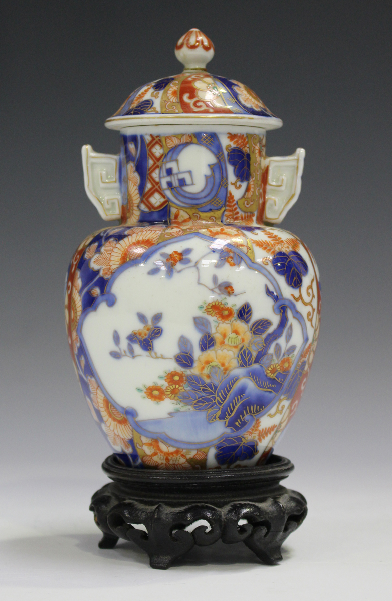 A Japanese Fukagawa Imari porcelain vase and cover, Meiji period, painted with panels of flowers,